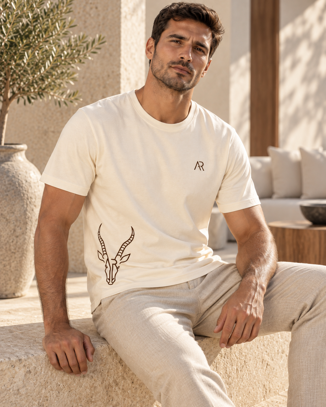 AR Essential Tee Homme K3032IC — Coconut Milk — lifestyle premium assis [ARV:coconut-milk:any:P02]
